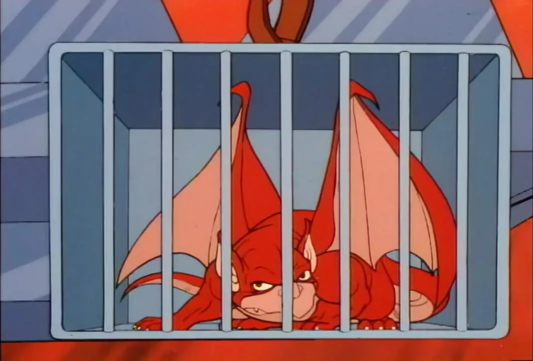 Sky-Shadow, the red bat-winged bird, sits caged after its delivery to Mon*Star's fortress.
